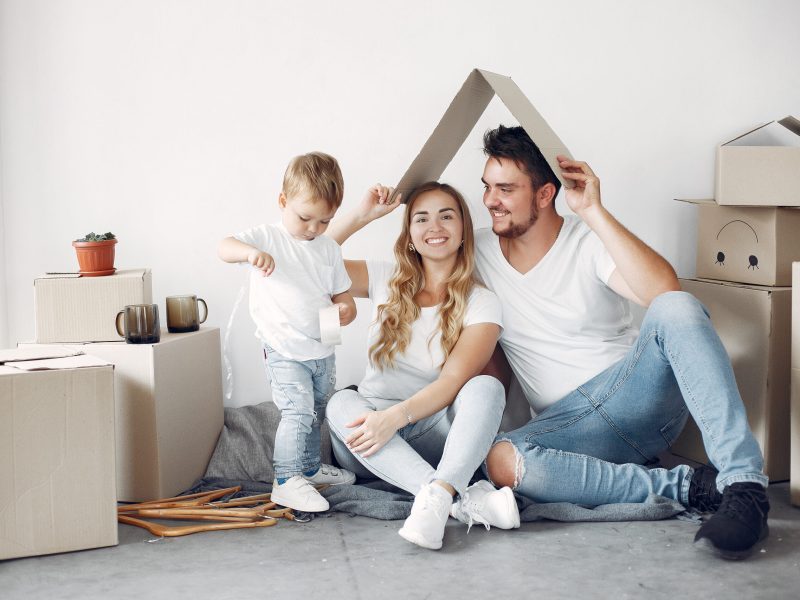 Family moving. People use a boxes. Little boy with parents.